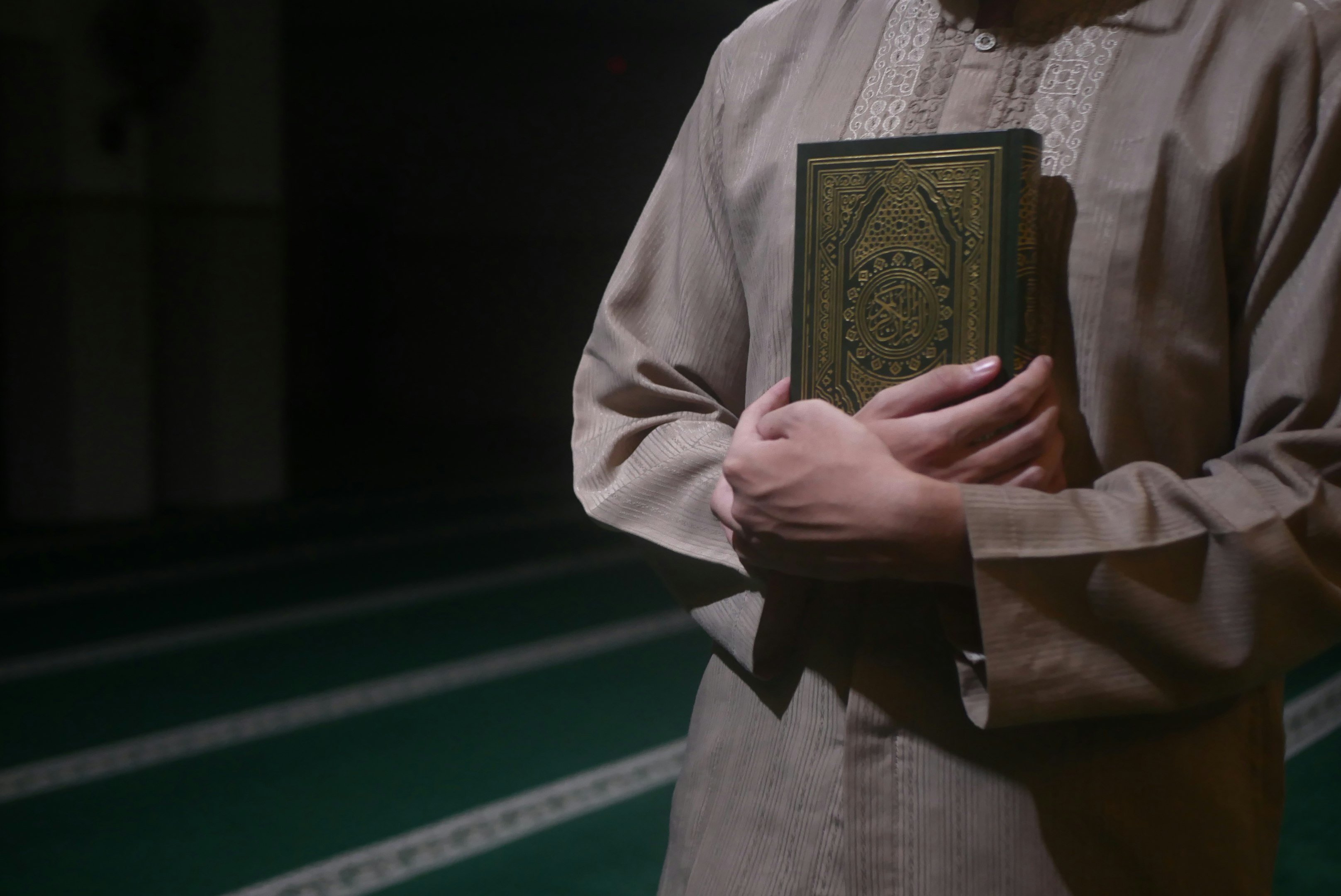 man hugging gold book